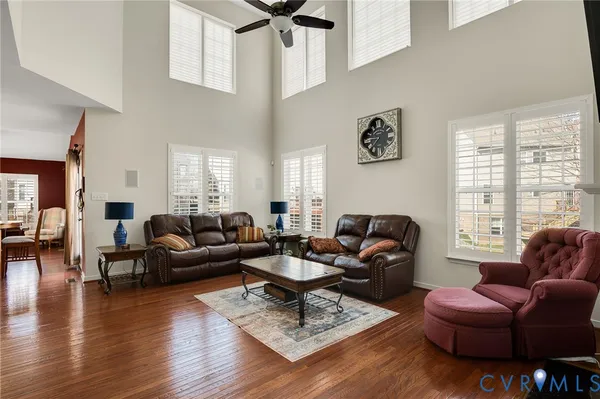 a kitchen with stainless steel appliances granite countertop dining table chairs stove and white cabinets