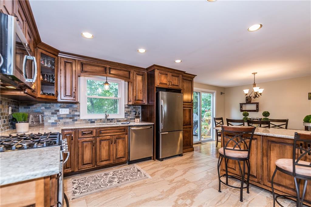 205 Wyngate Road Coraopolis, PA 15108 - Photo 2 of 25 New kitchen with Amish built cabinets with toe kick storage, quartz counter tops, ceramic tile backsplash, and stainless steel appliances.