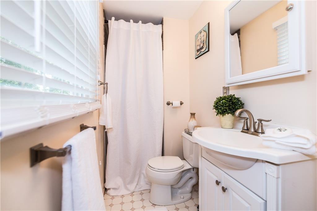 205 Wyngate Road Coraopolis, PA 15108 - Photo 12 of 25 Full master bathroom, with new vanity, mirror and lighting, walk in ceramic surround shower and window overlooking the tree tops.