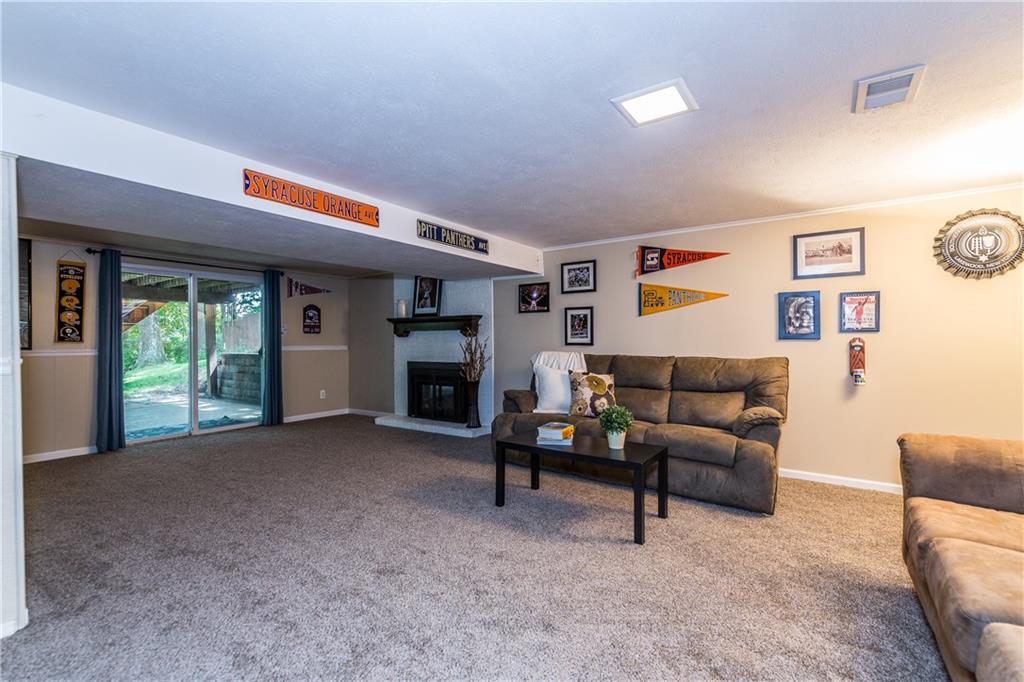 205 Wyngate Road Coraopolis, PA 15108 - Photo 17 of 25 Family room features a powder room, laundry room and sliding glass doors to a paved patio and new landscaped retaining wall, overlooking the picturesque mature landscaped yard.