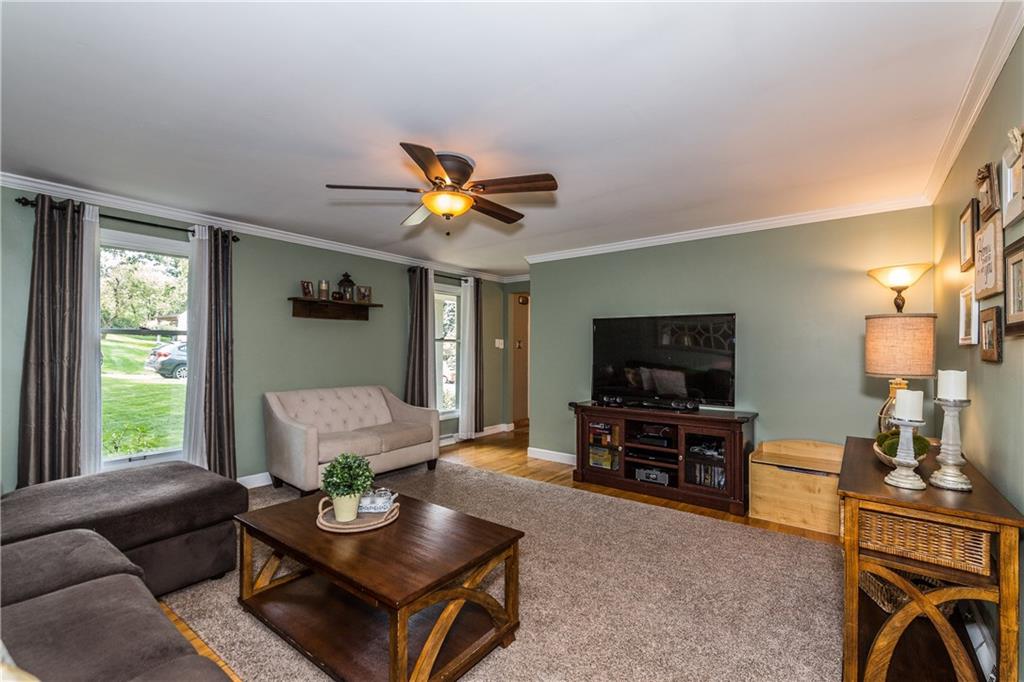 205 Wyngate Road Coraopolis, PA 15108 - Photo 9 of 25 The living room is infused with warmth and comfort achieved through natural light from the windows, oak hardwood floors, crown molding and ceiling fan for comfort.
