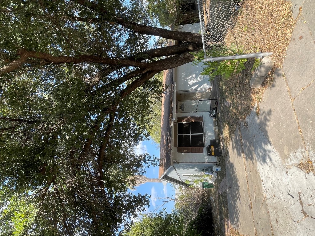 a front view of a house with a tree
