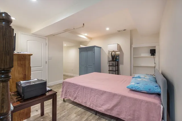 a bedroom with a bed and a television