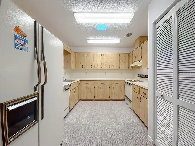 a kitchen with stainless steel appliances a refrigerator sink and microwave