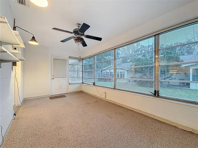 a view of room with window and ceiling fan