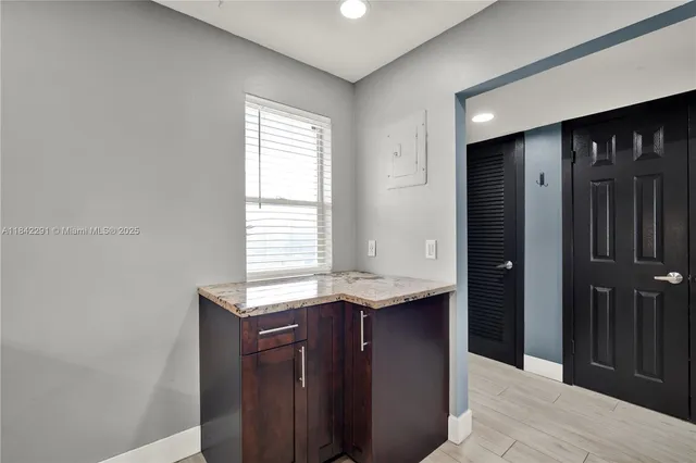 a view of a hallway with wooden shelves
