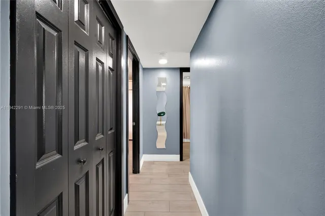 a view of a hallway with wooden floor