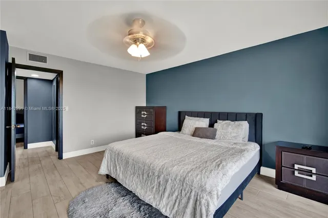 a bedroom with a bed and a lamp