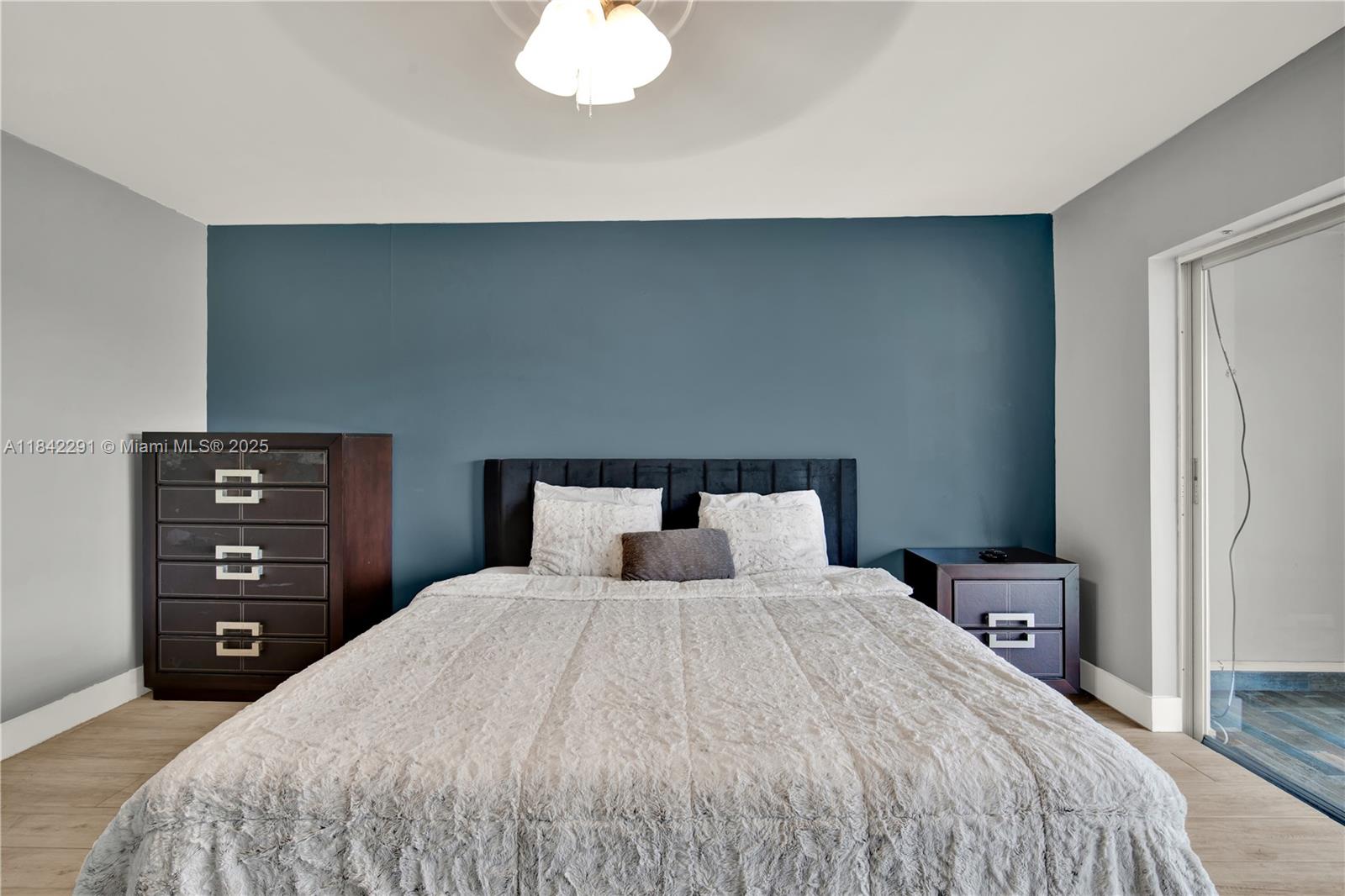 950 Hillcrest Drive, Unit 414 Hollywood, FL 33021 - Photo 17 of 35 a bedroom with a bed and a lamp