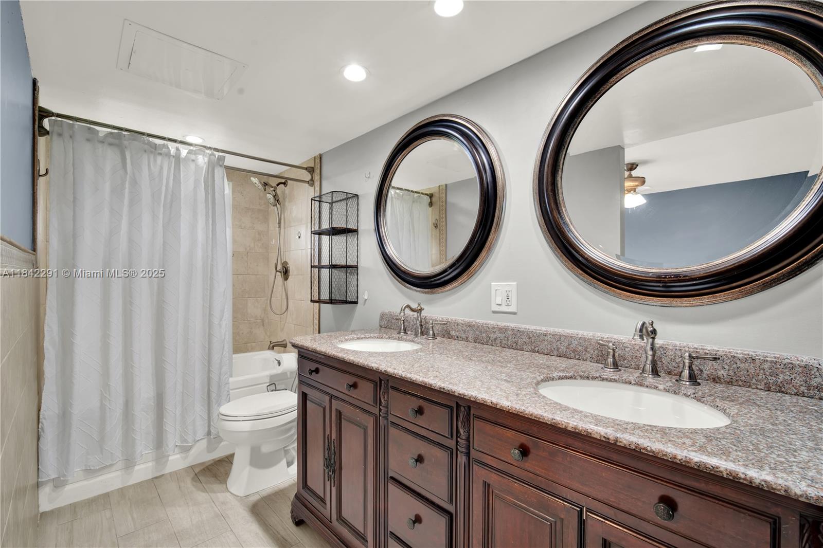 950 Hillcrest Drive, Unit 414 Hollywood, FL 33021 - Photo 19 of 35 a bathroom with 2 sink and a mirror