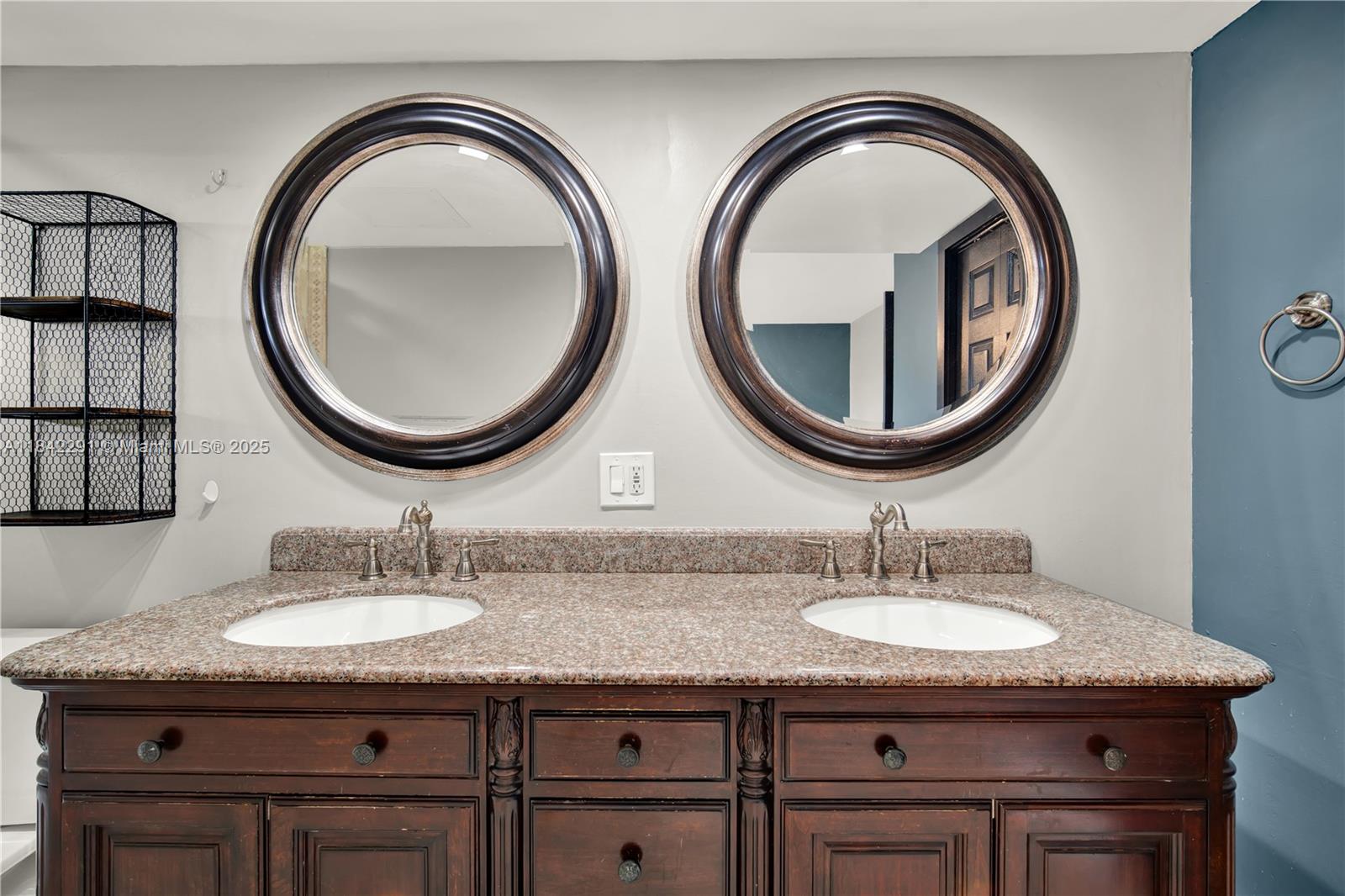 950 Hillcrest Drive, Unit 414 Hollywood, FL 33021 - Photo 20 of 35 a bathroom with a granite countertop double vanity sink and a mirror