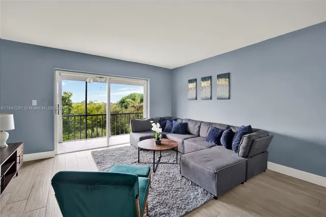 a living room with furniture and a large window