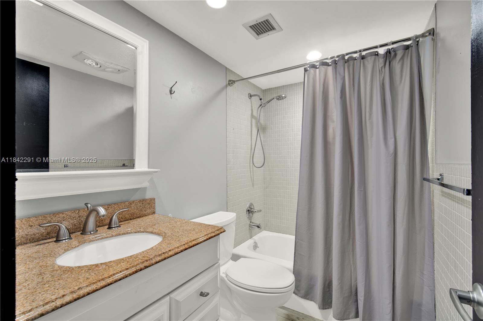 950 Hillcrest Drive, Unit 414 Hollywood, FL 33021 - Photo 23 of 35 a bathroom with a granite countertop sink toilet and shower