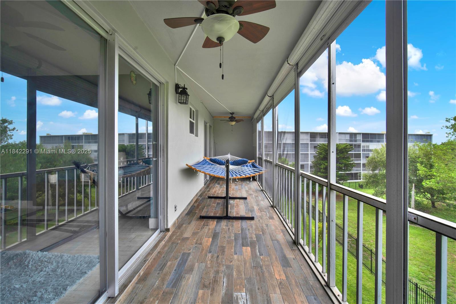 950 Hillcrest Drive, Unit 414 Hollywood, FL 33021 - Photo 25 of 35 a view of a balcony with furniture and wooden floor