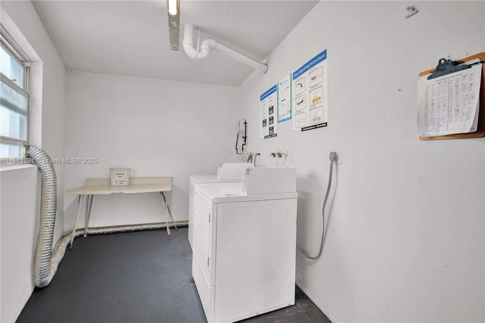 950 Hillcrest Drive, Unit 414 Hollywood, FL 33021 - Photo 30 of 35 a utility room with cabinets washer and dryer