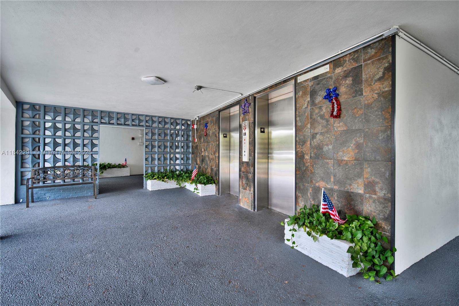 950 Hillcrest Drive, Unit 414 Hollywood, FL 33021 - Photo 31 of 35 a living room with furniture and flowers