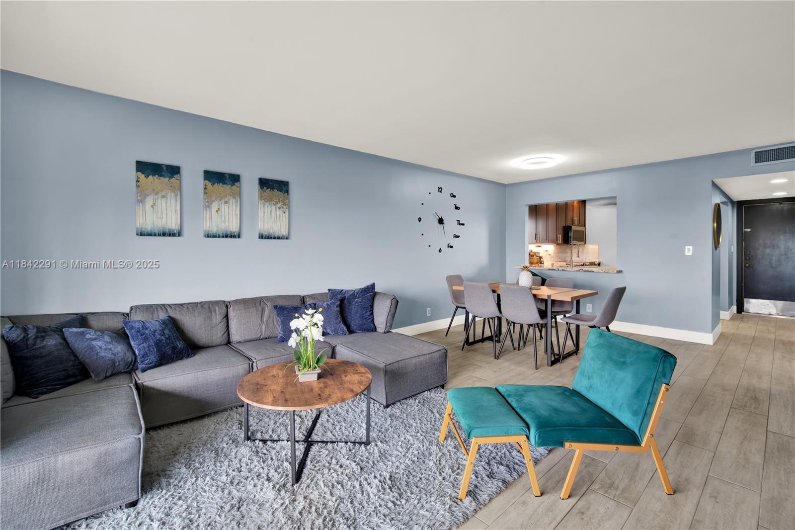 950 Hillcrest Drive, Unit 414 Hollywood, FL 33021 - Photo 5 of 35 a living room with furniture and a rug