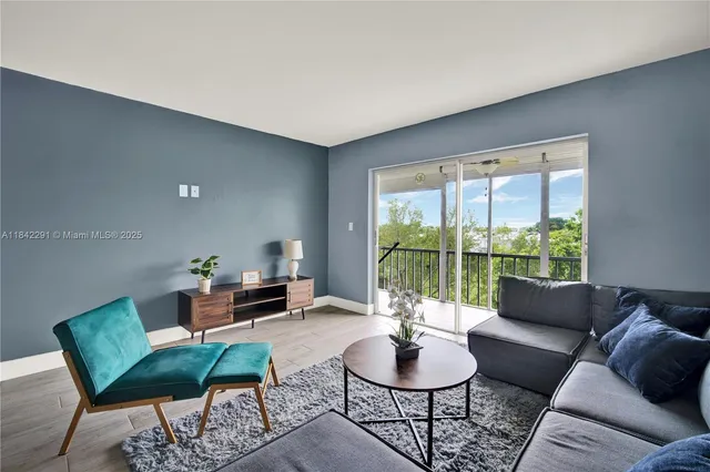 a living room with furniture and a large window