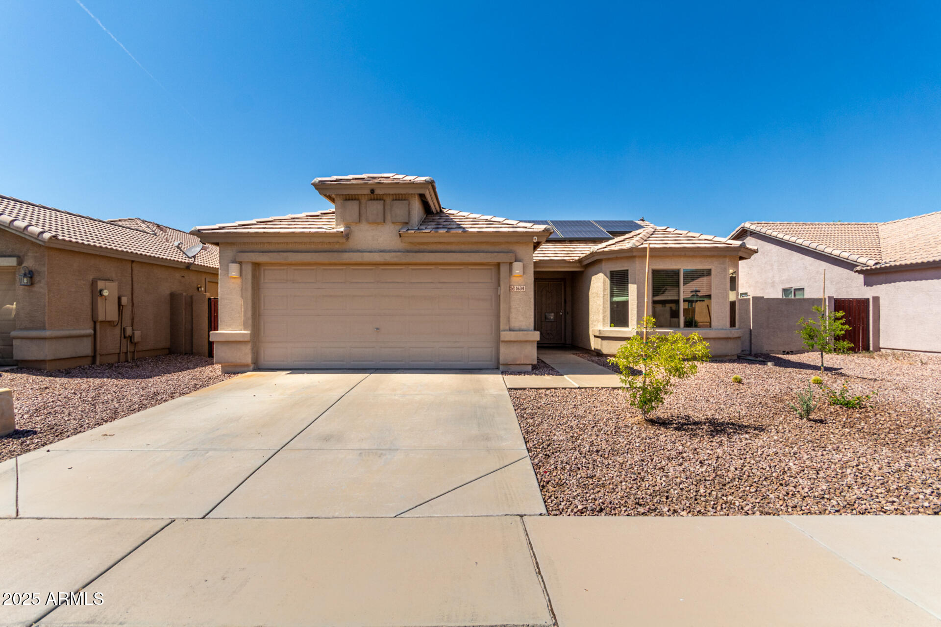 1634 East Harwell Road Phoenix, AZ 85042 - Photo 2 of 44 a front view of a house with a garden