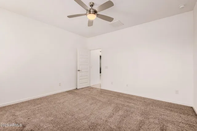 an empty room with a ceiling fan and a ceiling fan