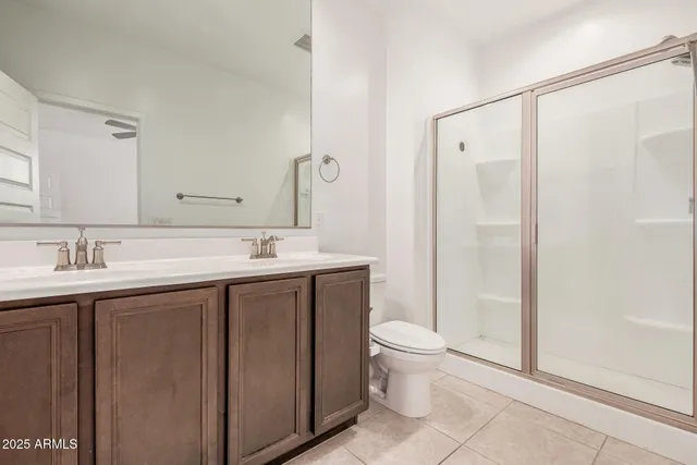 a spacious bathroom with a granite countertop sink a toilet and shower