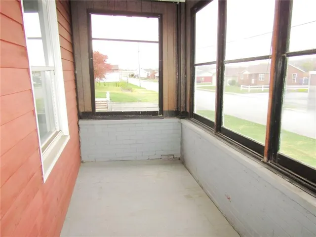 a view of an empty room and a window