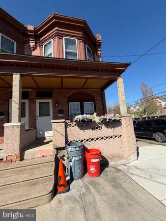 a view of a patio with table and chairs under an umbrella