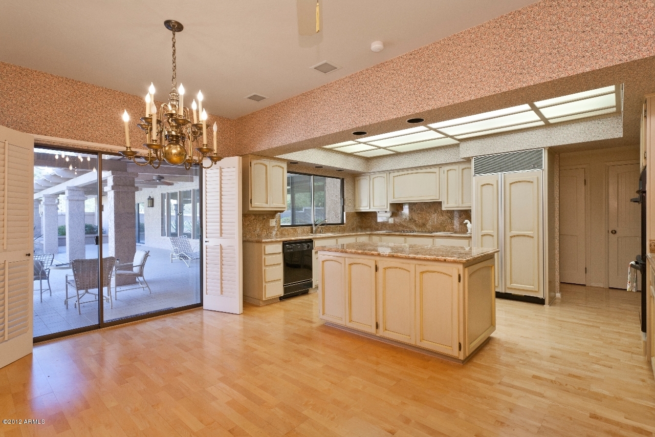 4444 East Camelback Road, Unit 22 Phoenix, AZ 85018 - Photo 11 of 26 a kitchen with granite countertop a refrigerator and a stove top oven
