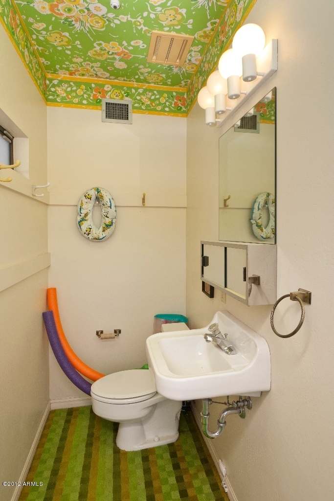 4444 East Camelback Road, Unit 22 Phoenix, AZ 85018 - Photo 19 of 26 a bathroom with a sink mirror and toilet