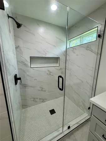 a bathroom with a glass shower door