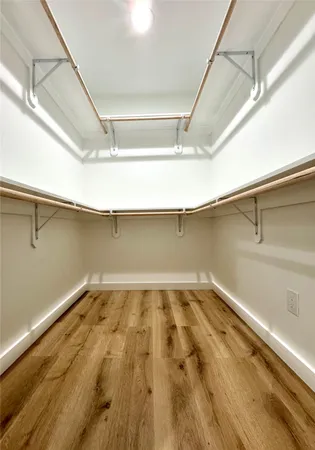 a view of a room with wooden floor