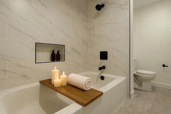 a bathroom with a tub shower and toilet