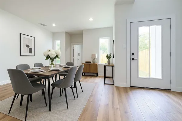 a view of a dining room with furniture and wooden floor
