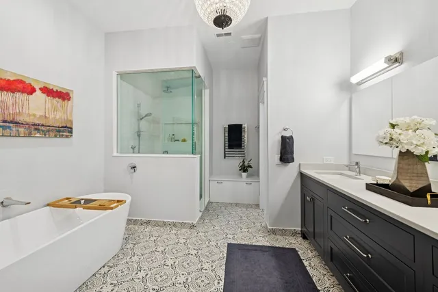 a bathroom with a tub sink and mirror