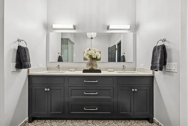 a bathroom with a double vanity sink and a mirror