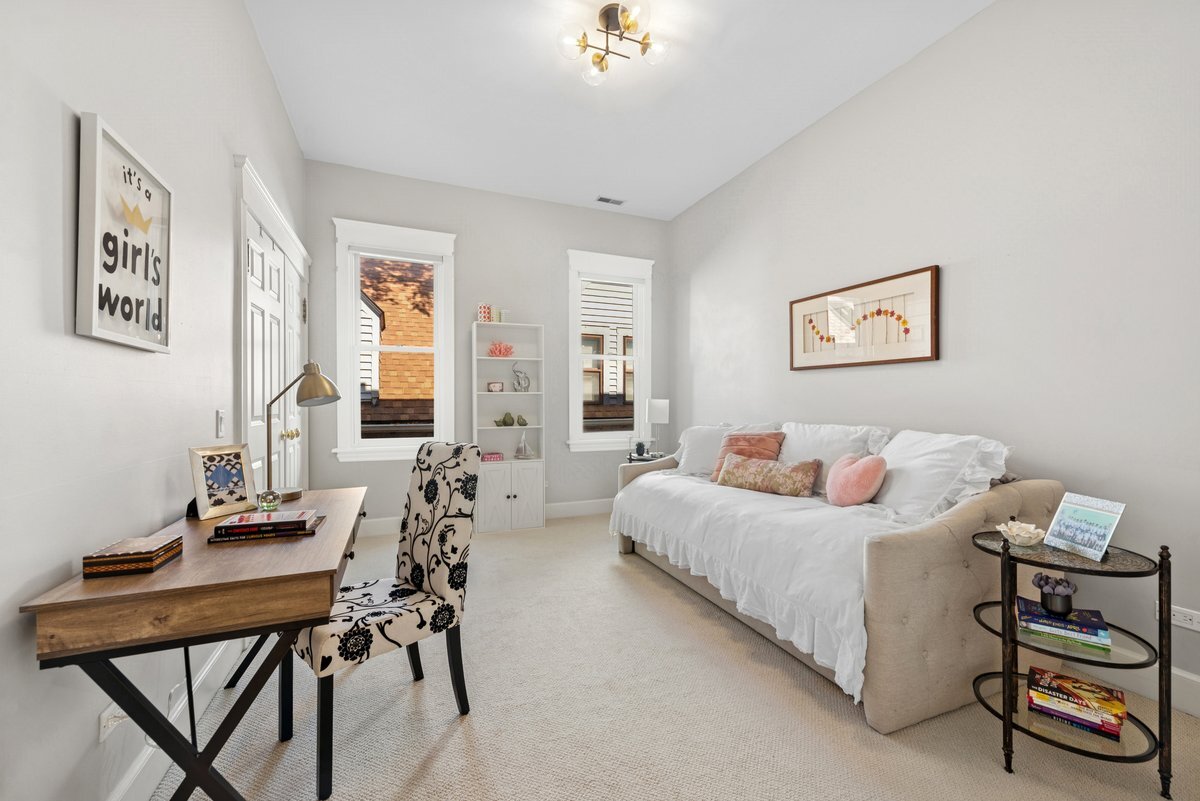 2661 North Dayton Street Chicago, IL 60614 - Photo 21 of 41 a bedroom with a bed and a chandelier