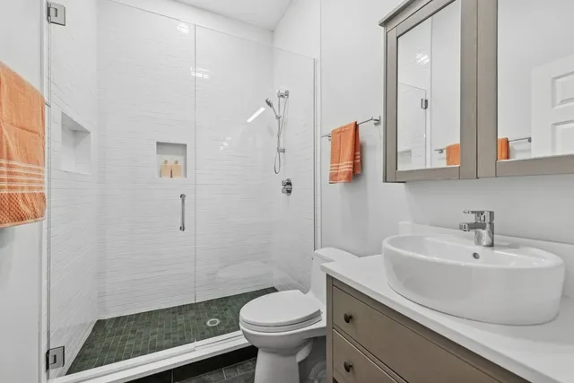 a bathroom with a sink toilet and shower