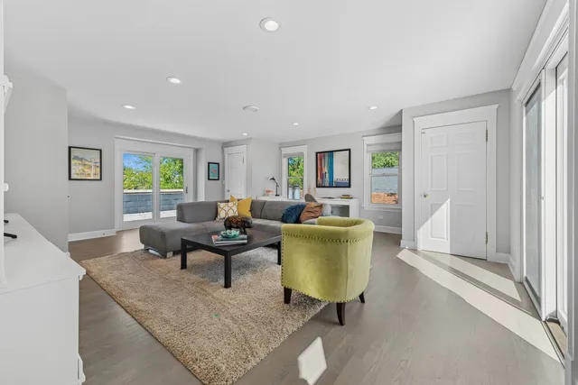 a living room with furniture a window and a table