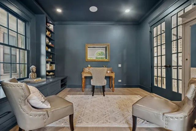 a living room with furniture a piano and a window