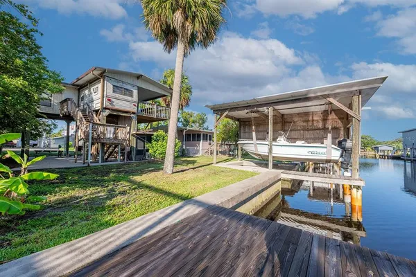 a view of a house with pool yard and outdoor seating