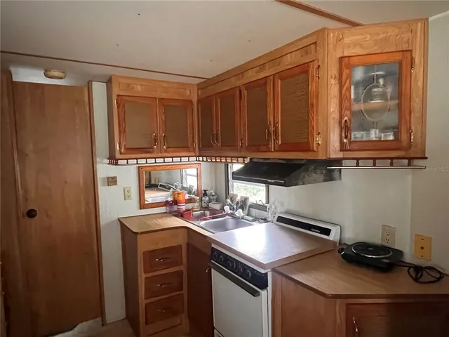 a kitchen with stainless steel appliances granite countertop a refrigerator and a stove