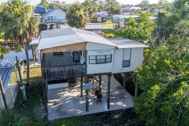 an aerial view of a house with balcony and garden