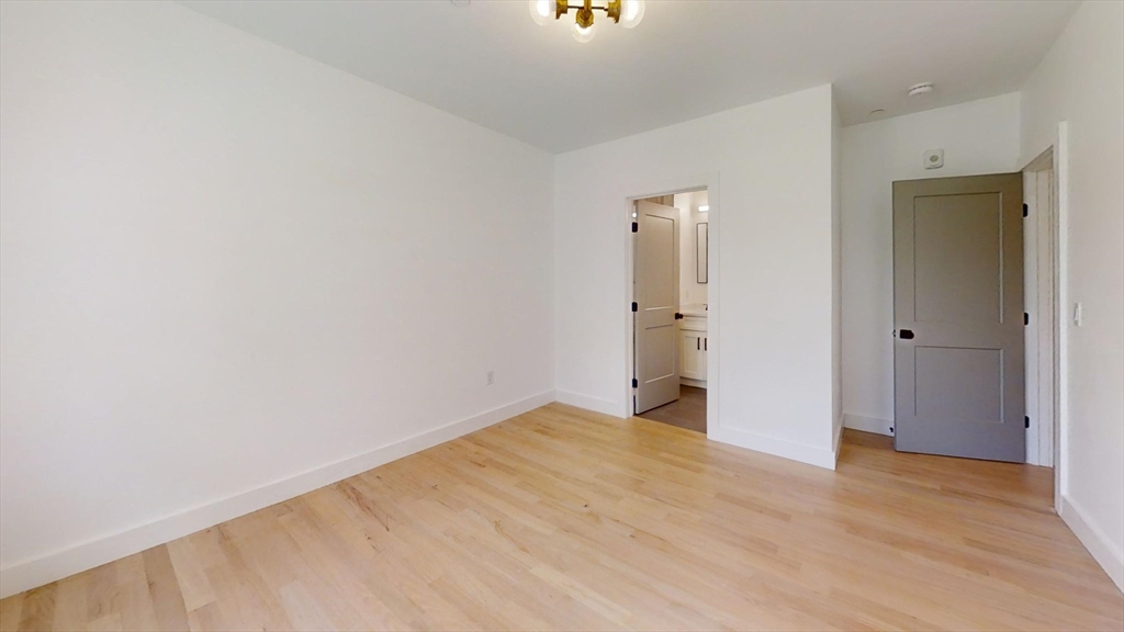 52 Withington Street, Unit 7 Boston, MA 02124 - Photo 12 of 19 a view of an empty room with wooden floor