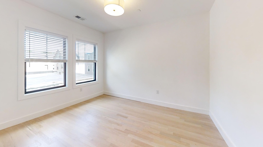 52 Withington Street, Unit 7 Boston, MA 02124 - Photo 13 of 19 an empty room with windows