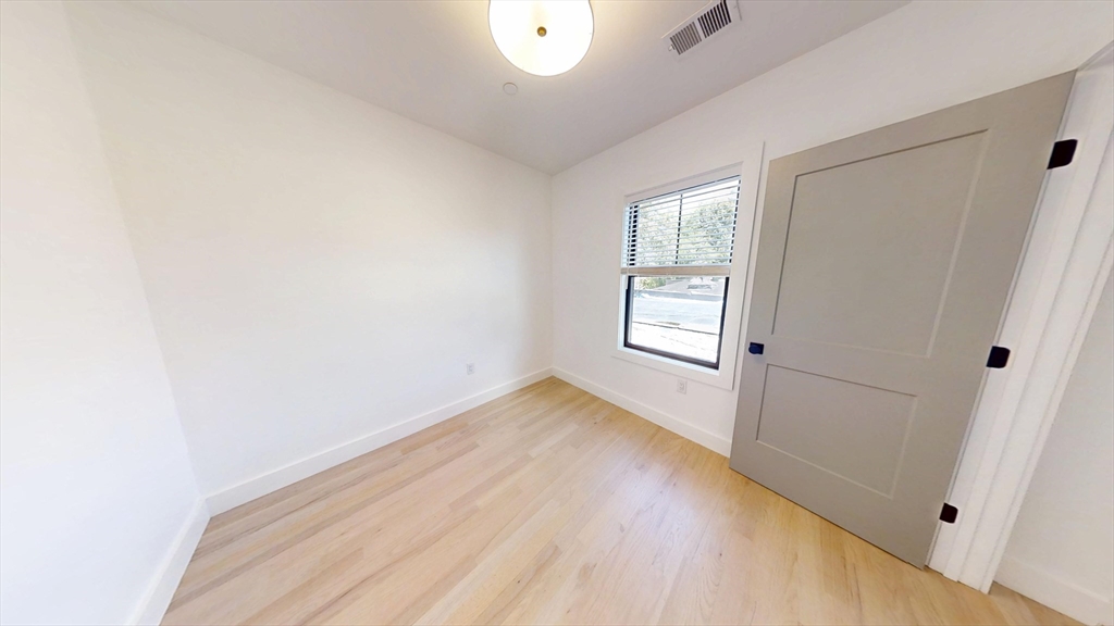 52 Withington Street, Unit 7 Boston, MA 02124 - Photo 4 of 19 a view of an empty room and window