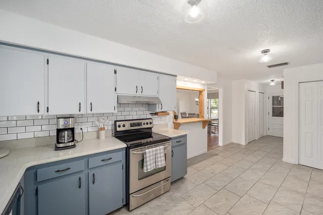 a kitchen with cabinets and appliances