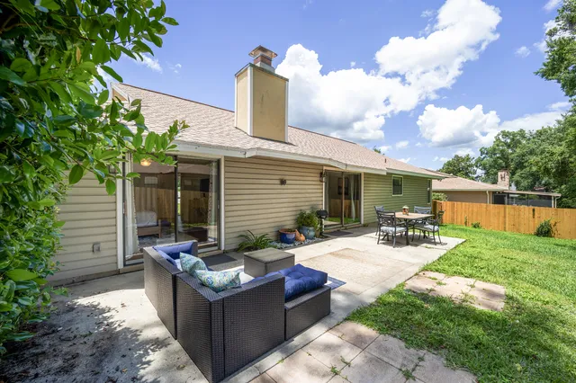 a view of a house with backyard sitting area and garden