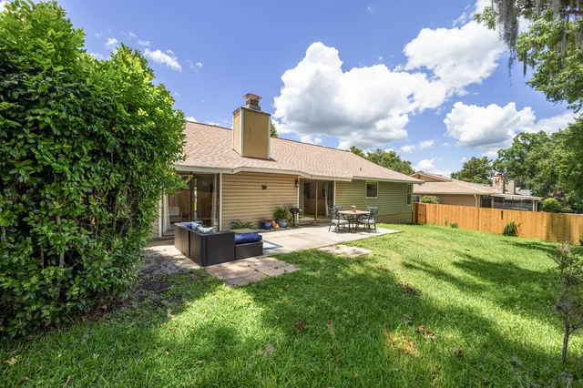 a view of a house with sitting area and garden