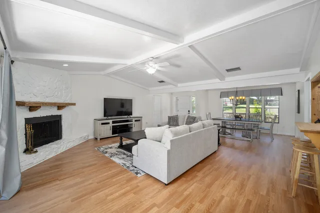 a living room with furniture fireplace and flat screen tv
