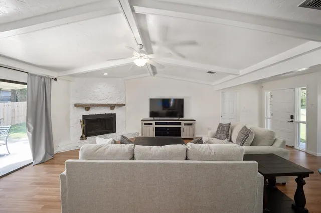 a living room with furniture and a flat screen tv
